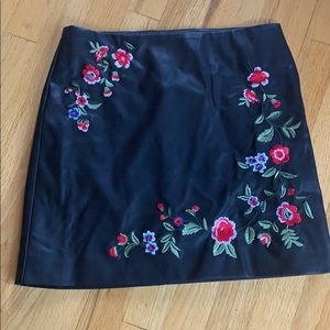 Black faux leather skirt with flower details